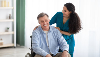 senior man in wheelchair with his caregiver