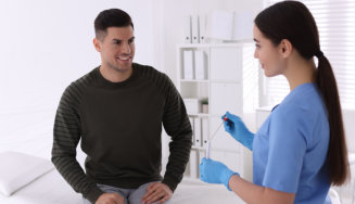 adult man consulting a healthcare person