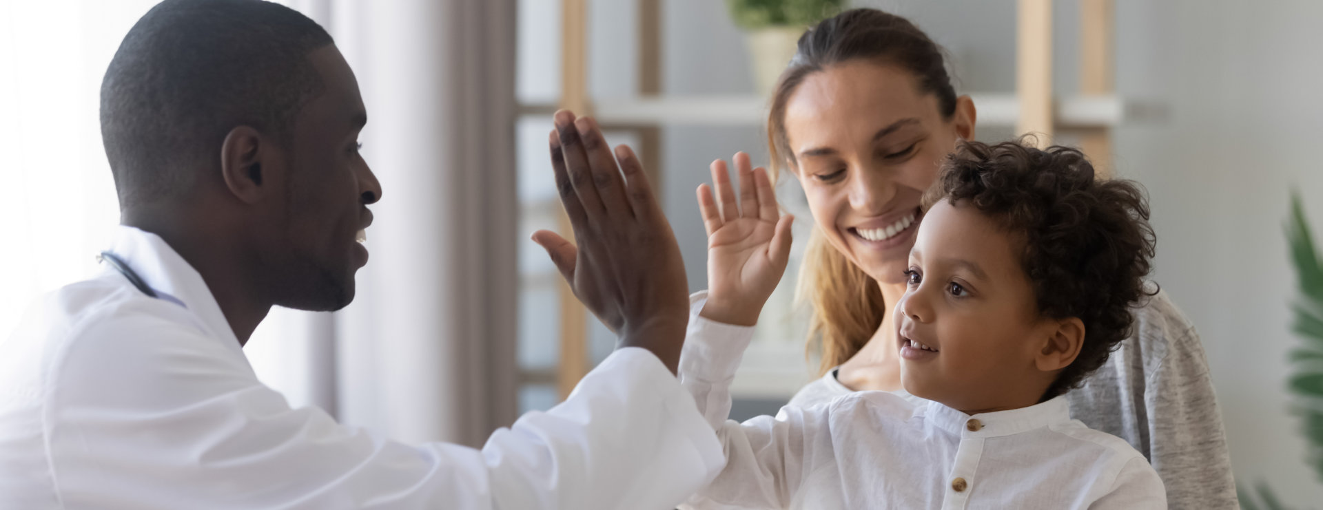 child giving high five to doctor