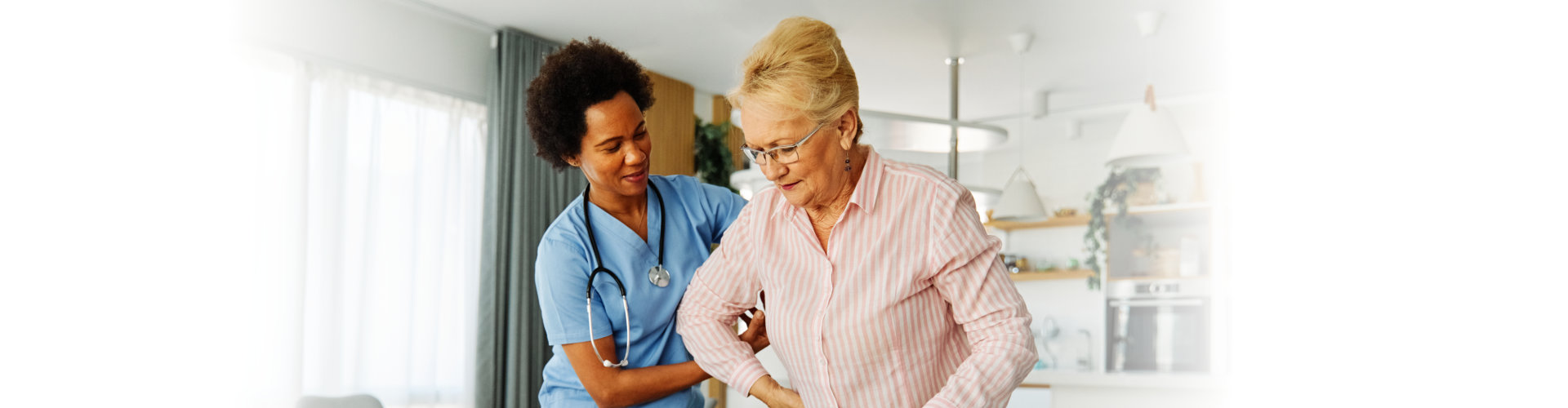 nurse helping senior woman